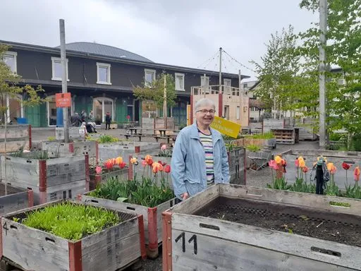 Storyteller vor Kisten mit Blumen und Gemüse
